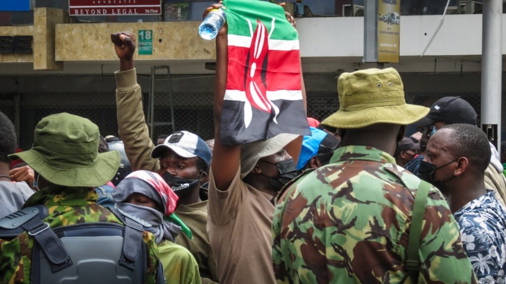 Kenyan citizens holding the national flag during a public demonstration